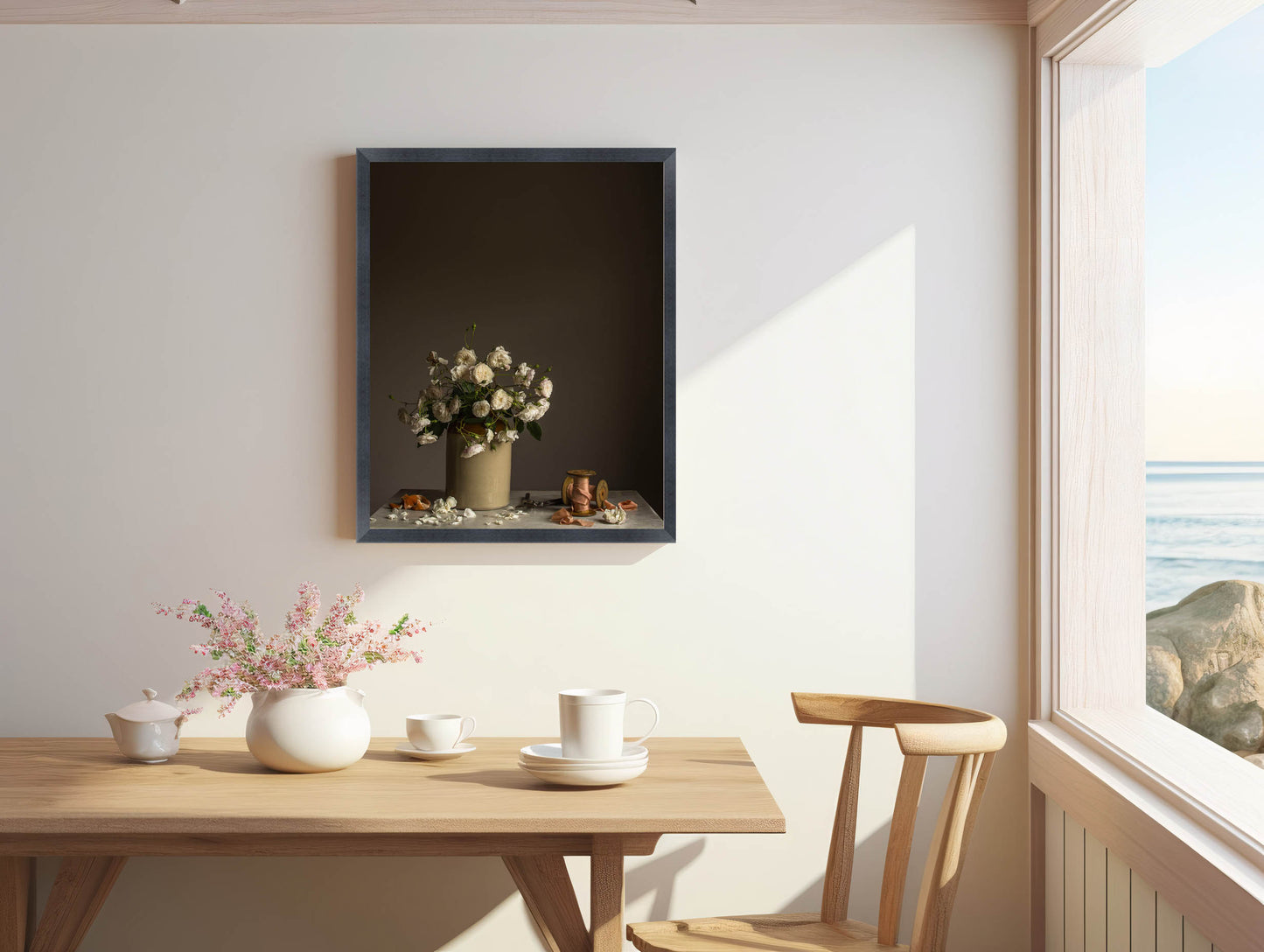 Dining area with a wooden table, chairs, and decorative items against a white wall. Floral art.