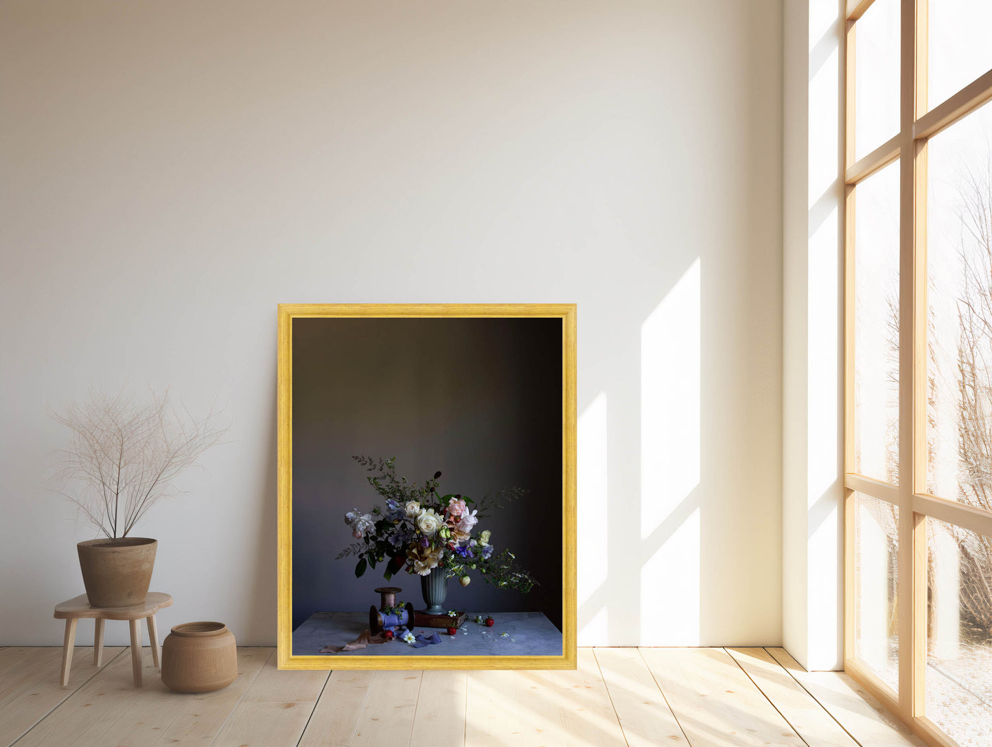 Framed artwork with a floral arrangement in a room with large windows. Botanical artwork