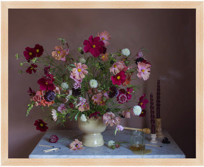 Framed still-life of flowers in a vase on a table with a dark background by Emma Harris
