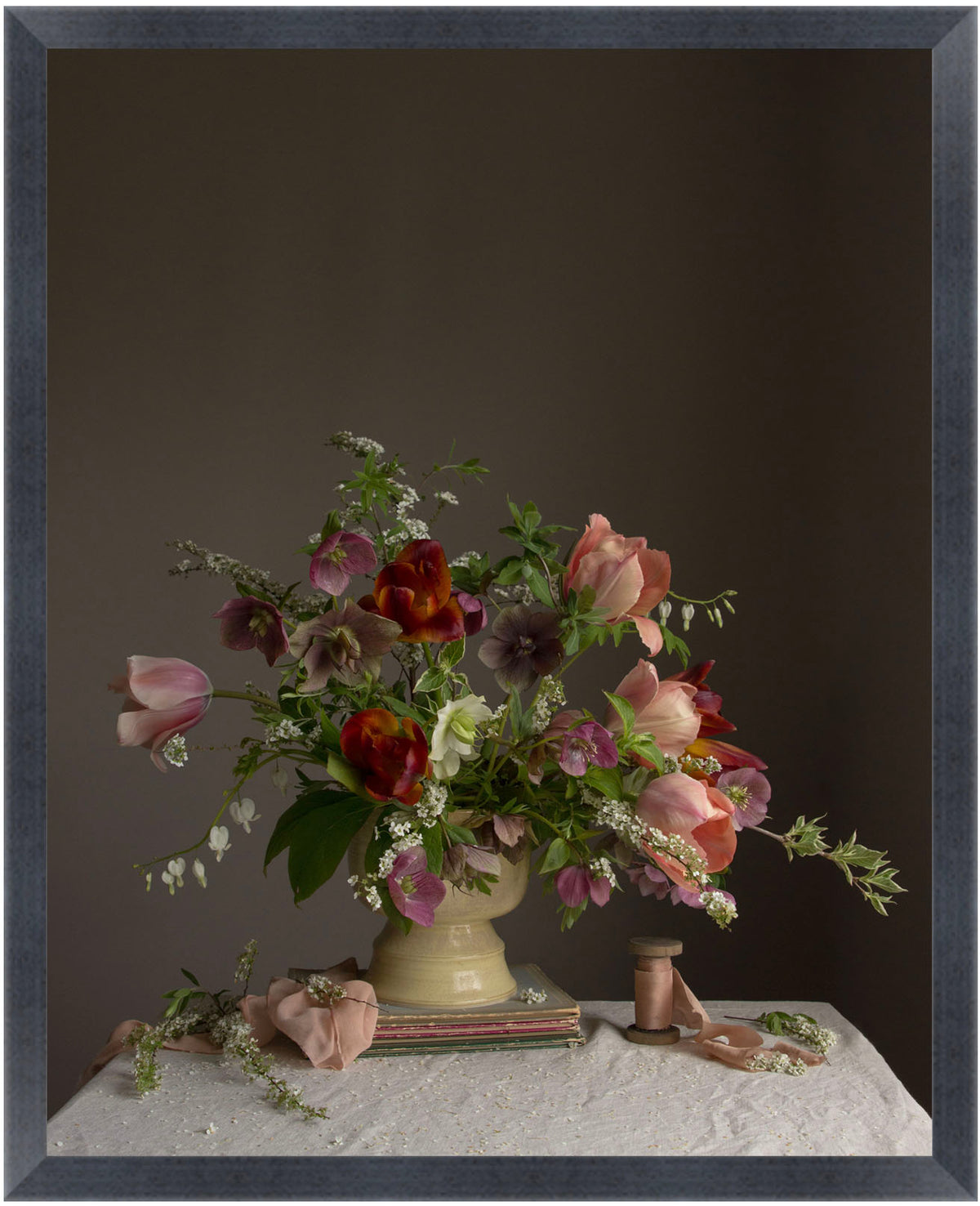 Floral arrangement in a vase on a table with a dark background.  Flower photograph