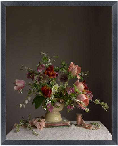 Floral arrangement in a vase on a table with a dark background.  Flower photograph