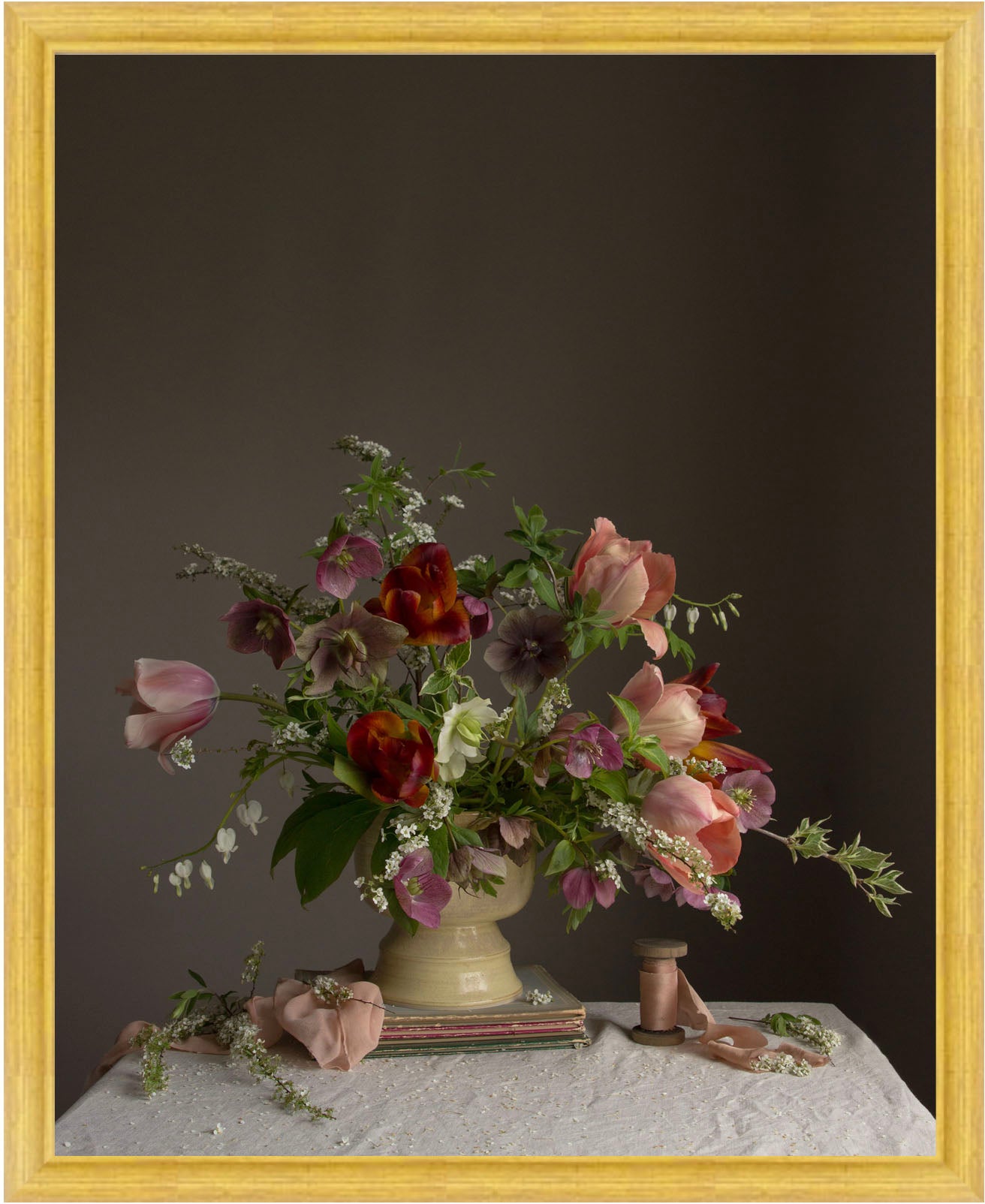 Floral picture of flowers in a vase on a table with a dark background