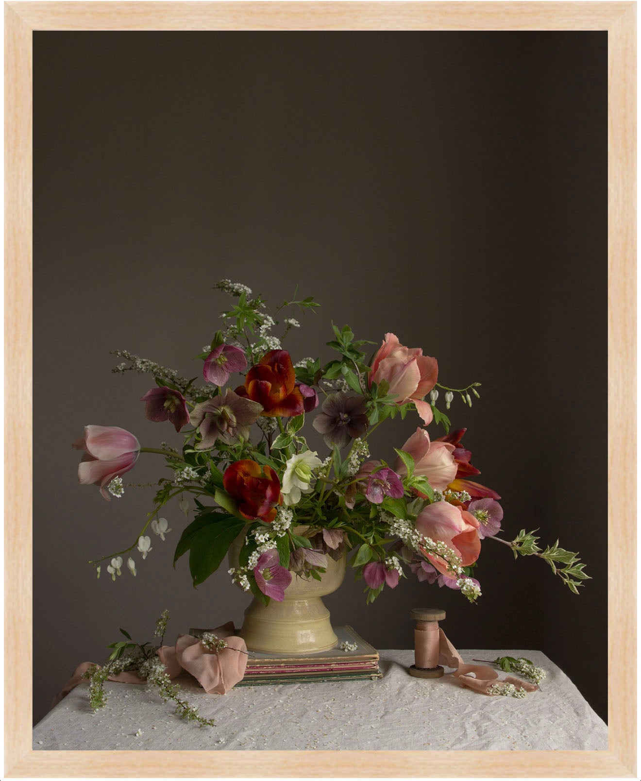 Floral arrangement in a vase on a table with a dark background.  Flower picture