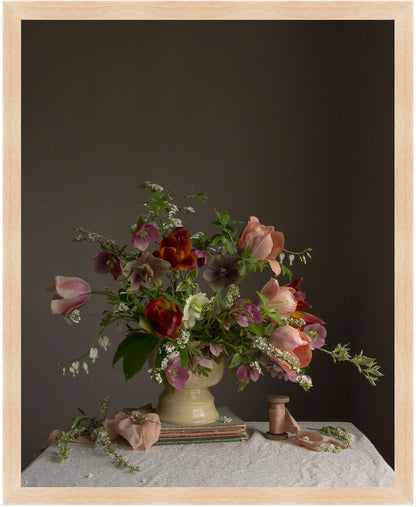 Floral arrangement in a vase on a table with a dark background.  Flower picture