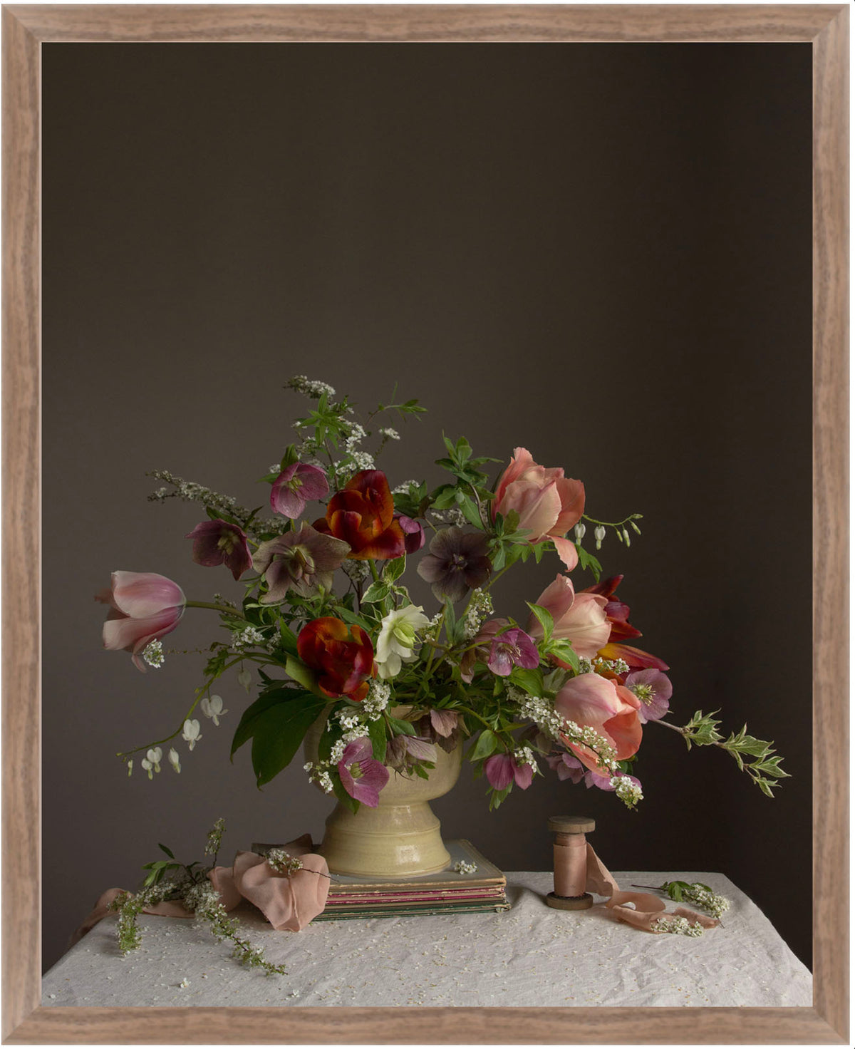Floral arrangement in a vase on a table with a dark background.  Botanical picture.