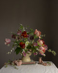 A limited edition fine art botanical photograph featuring a floral arrangement of tulips and hellebores in a vase by Emma Harris