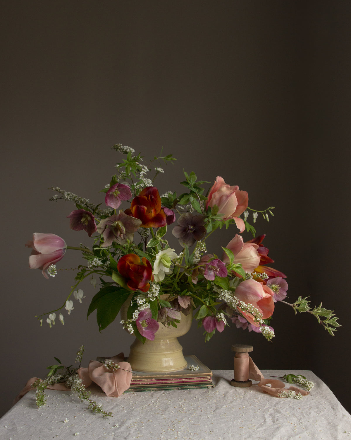 A limited edition fine art botanical photograph featuring a floral arrangement of tulips and hellebores in a vase by Emma Harris