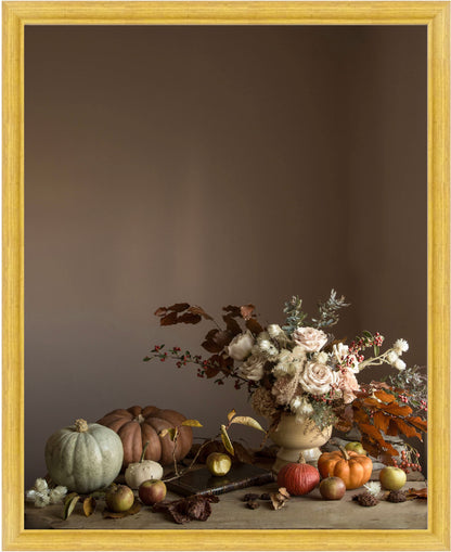 Framed Floral still-life with pumpkins and flowers on a wooden surface against a brown background.