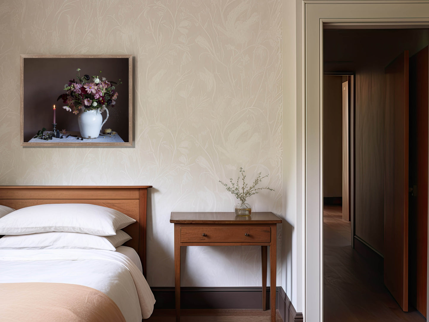 Bedroom with wooden bed, nightstand, and wall art of flowers.