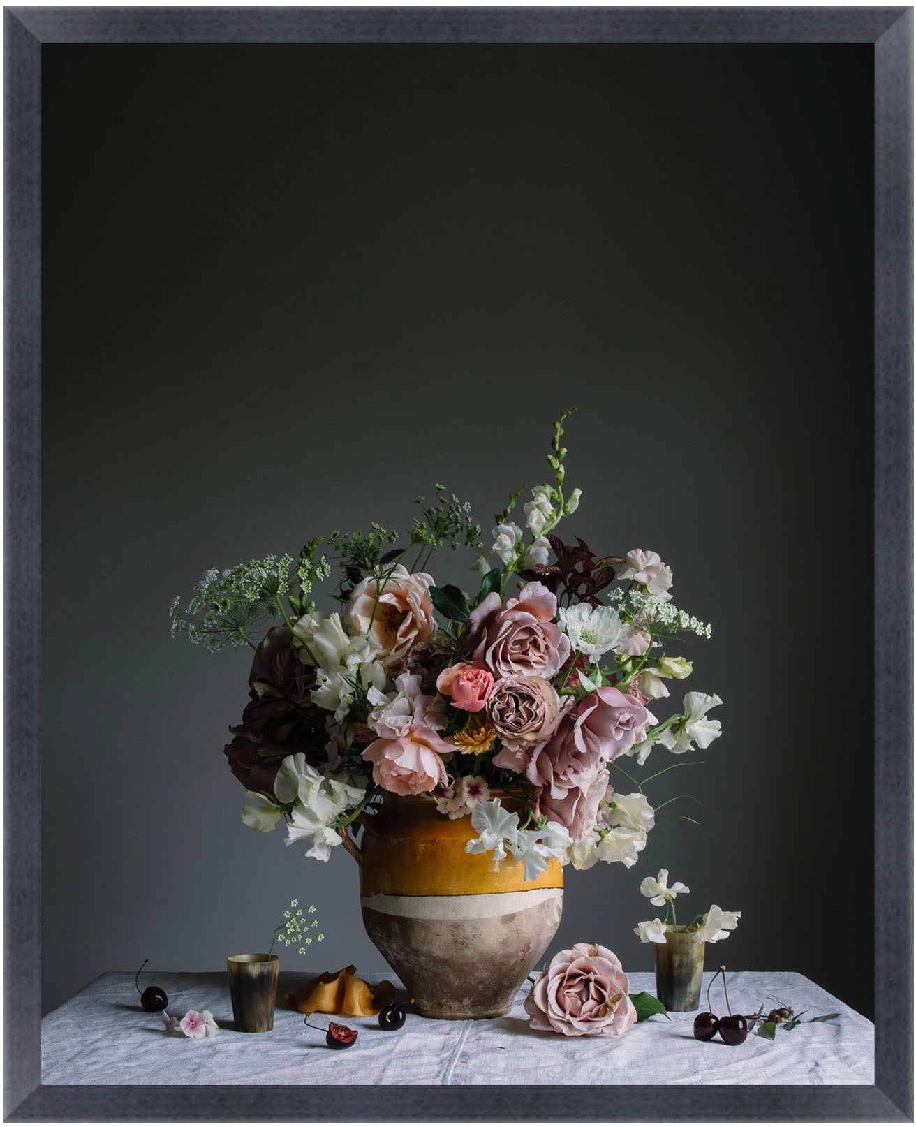 Floral arrangement in a vase on a table with a dark background.   Botanical print