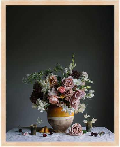 Floral arrangement in a vase on a table with a dark background.   Flower photography