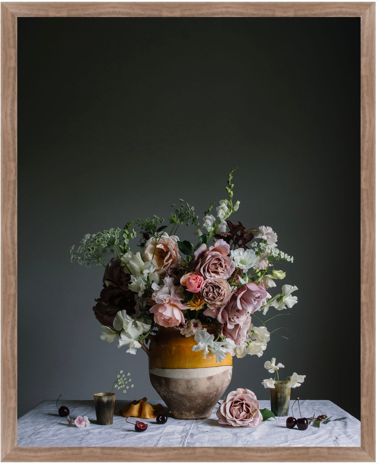 Floral arrangement in a vase on a table with a dark background.   Botanical photography