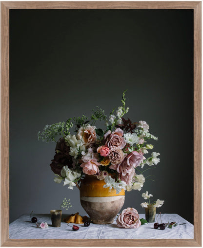 Floral arrangement in a vase on a table with a dark background.   Botanical photography