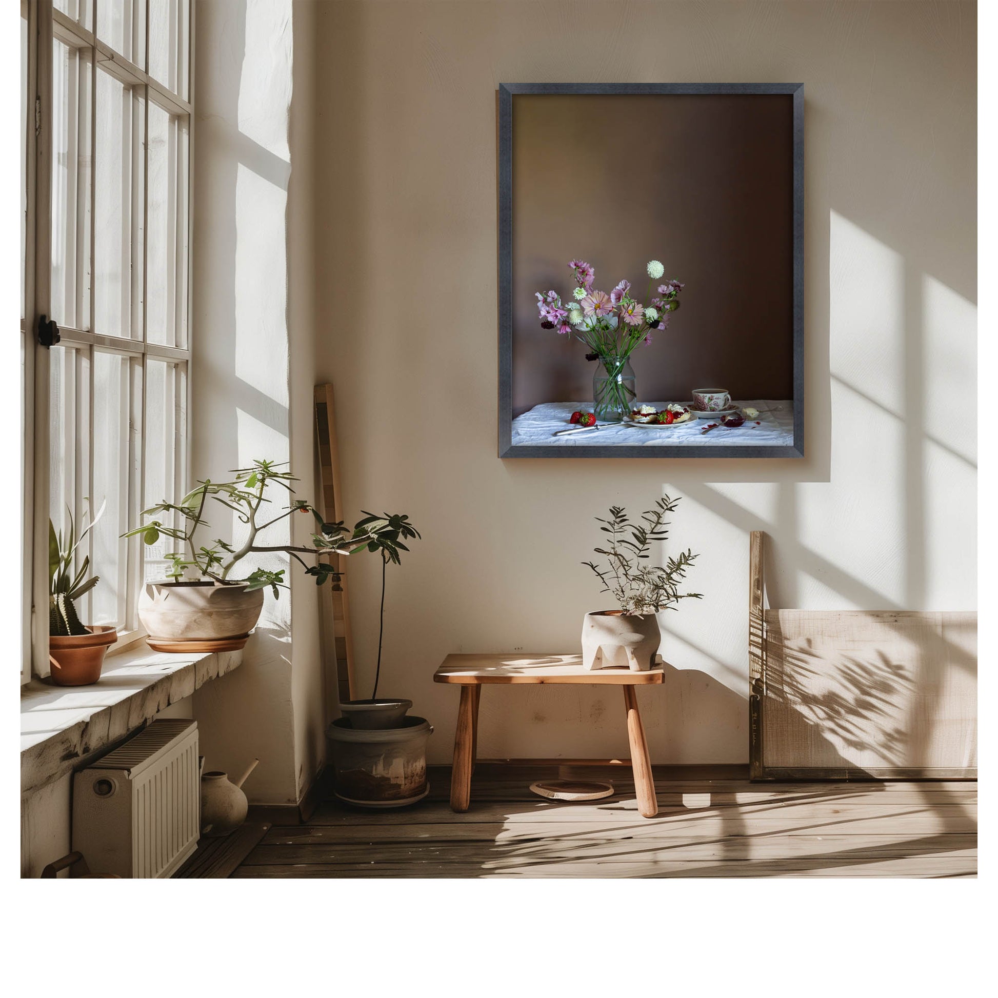 Living room with a vase of flowers on a table, framed floral still-life picture on the wall, and plants.