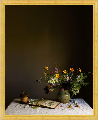 Still life scene with a vase of flowers on a table against a dark background.  flower print