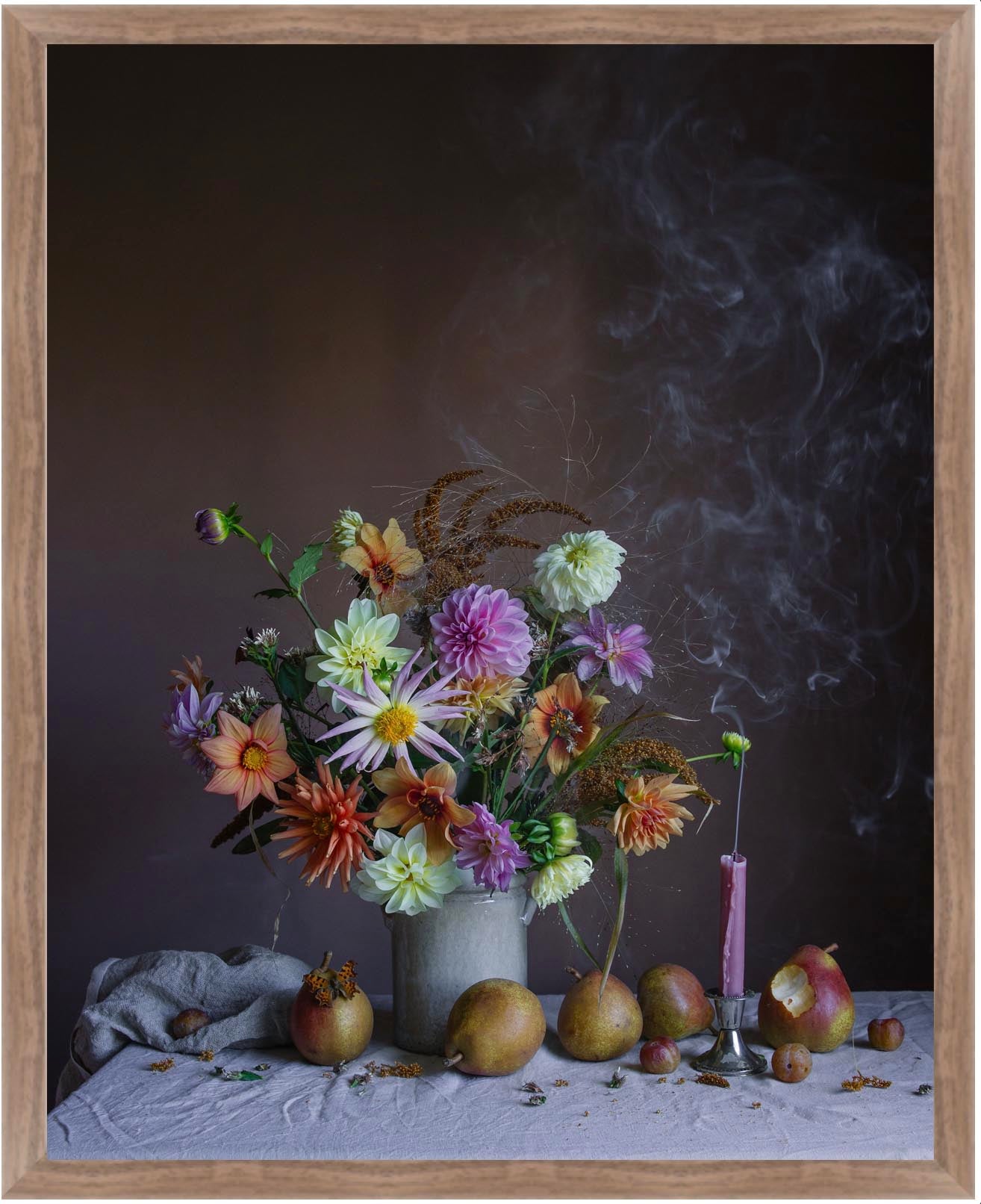 Still life arrangement with flowers, pears, and a candle on a dark background in a walnut frame