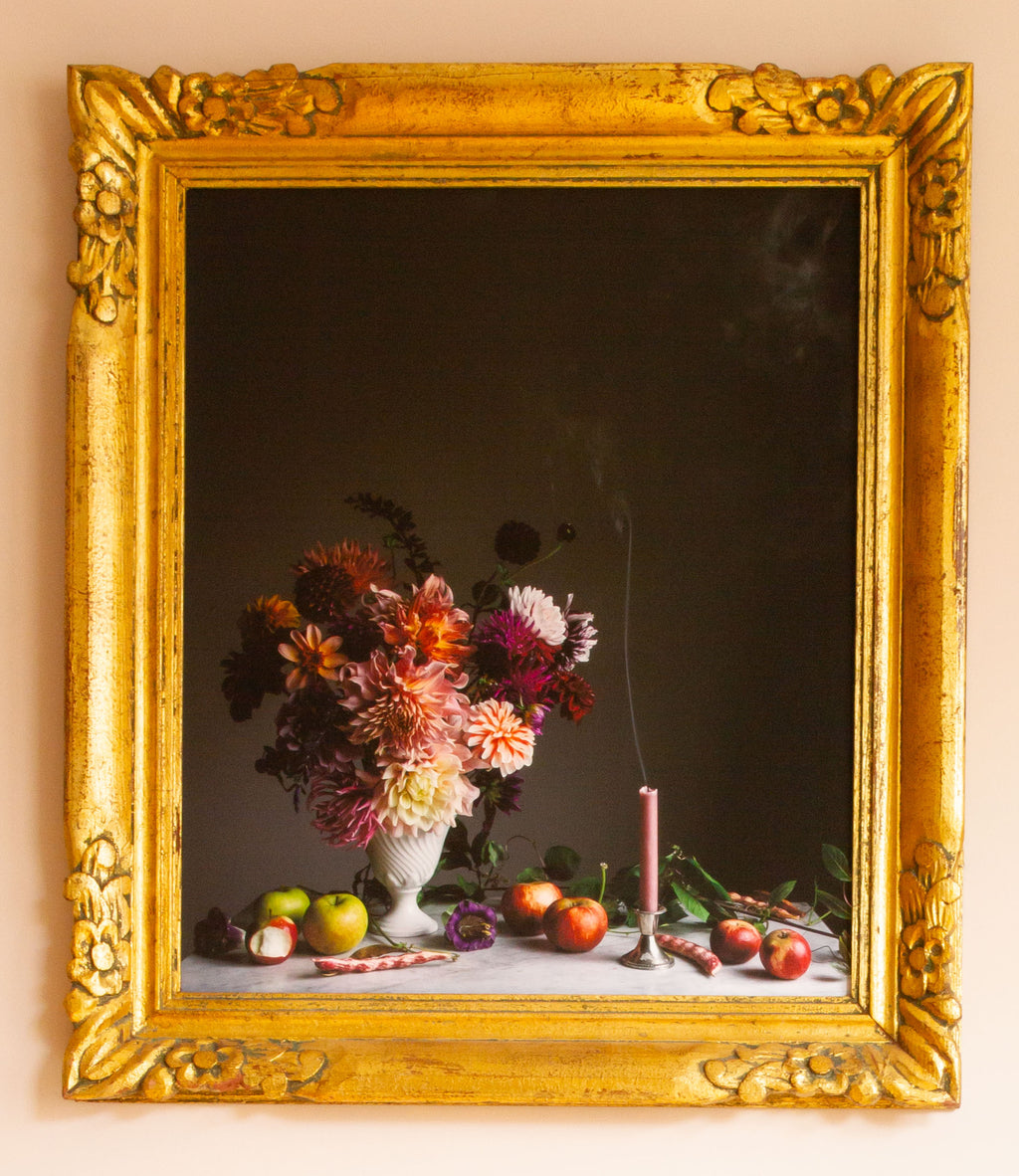 Still life photograph with flowers and fruits in a gold frame by Emma Harris