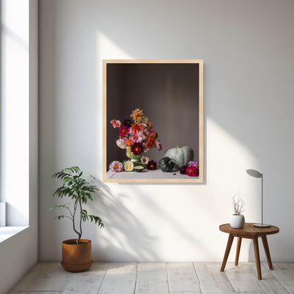 Framed artwork of a still life with flowers and fruits on a wall in a room with a plant and small table.  Still life photograph