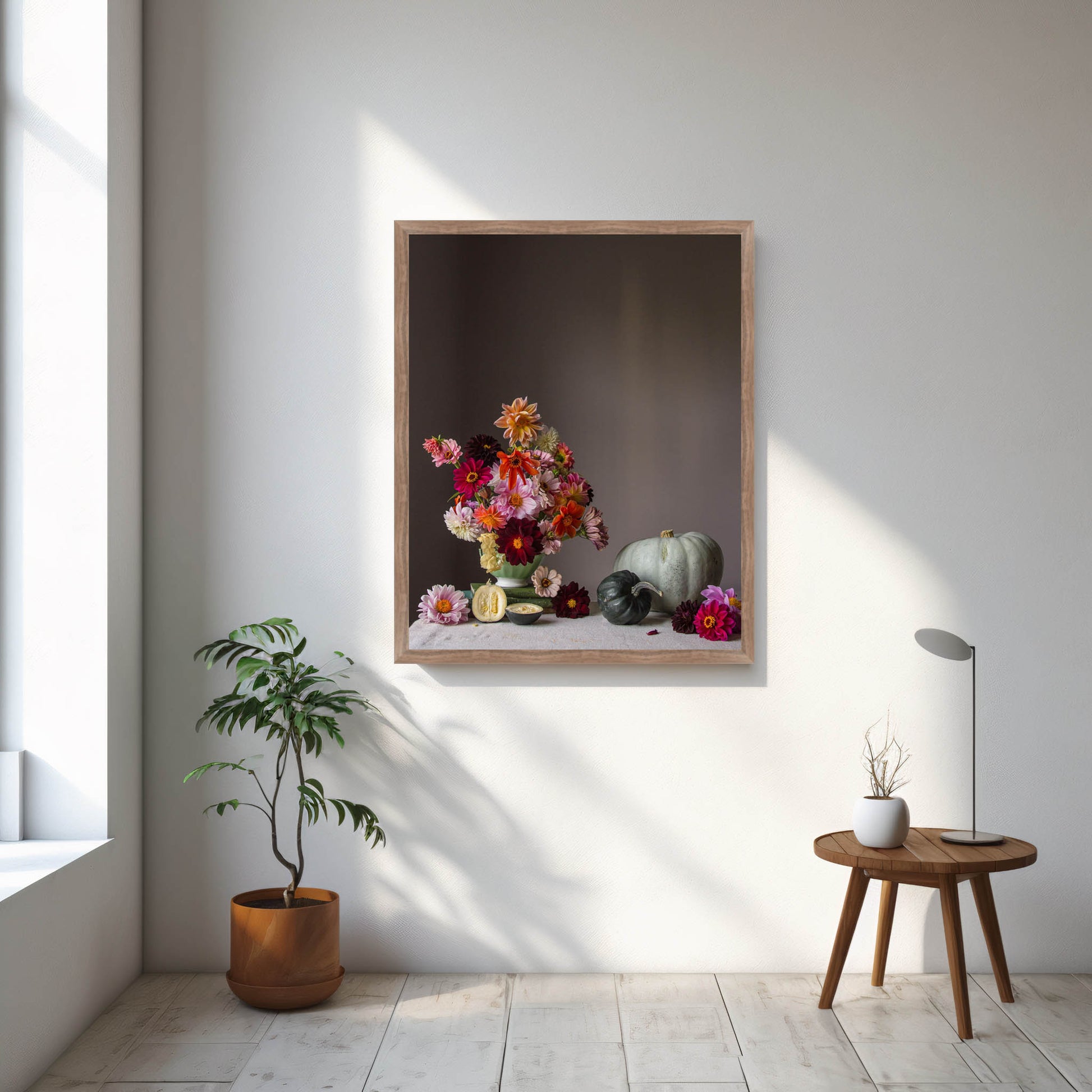 Framed artwork of a still life with flowers and vegetables on a wall in a bright room.   Floral photograph.