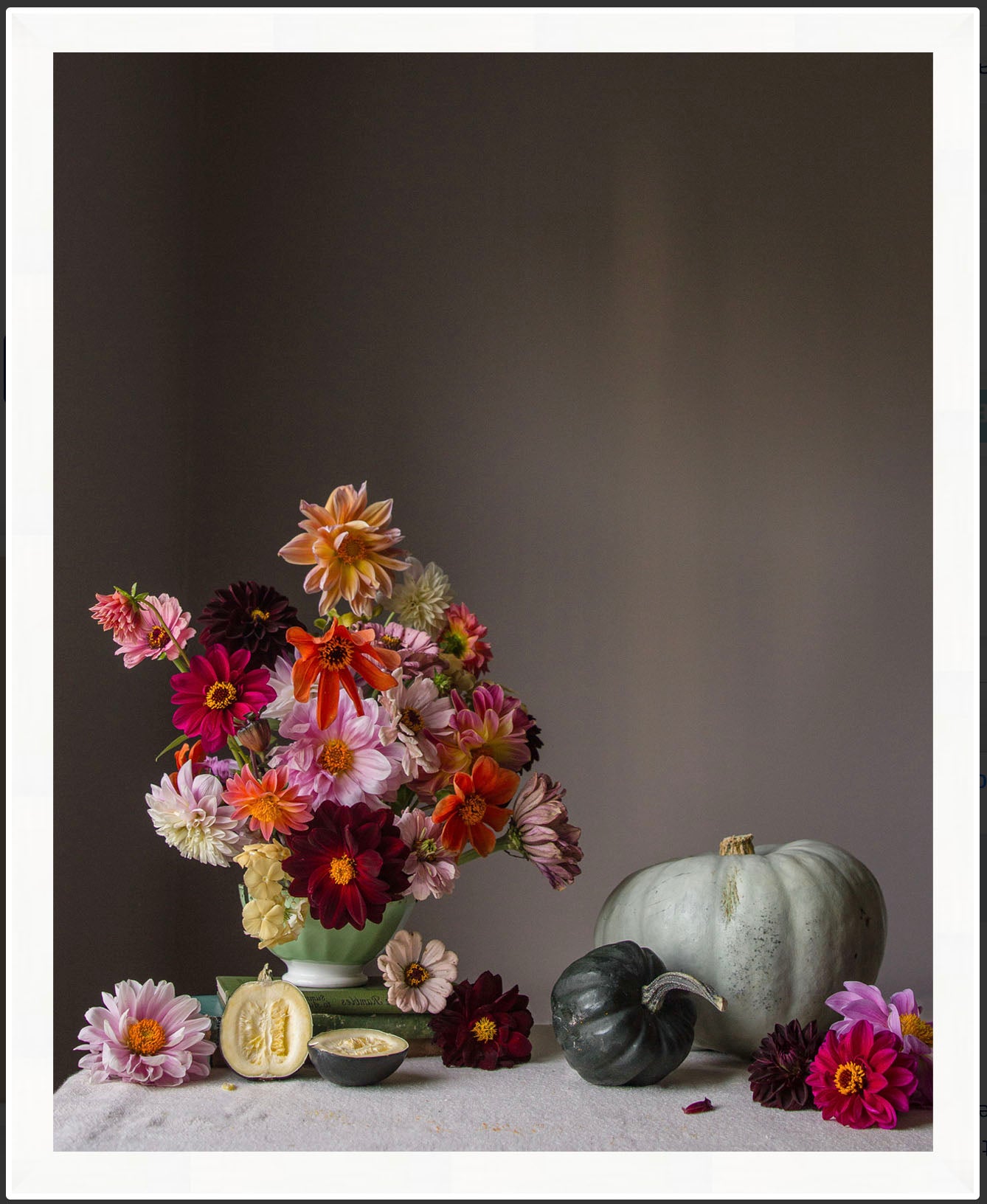 Bouquet of flowers with pumpkins on a dark background.   Floral print.
