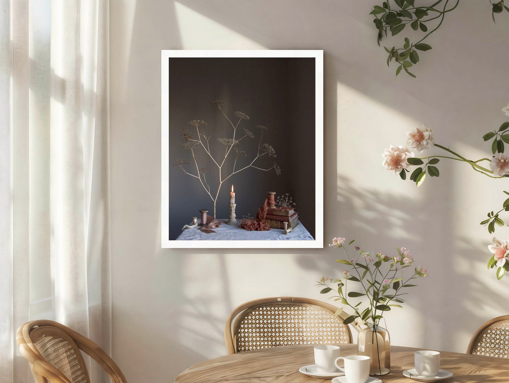 Framed artwork on a wall with a table and chairs in the foreground.  Floral still-life