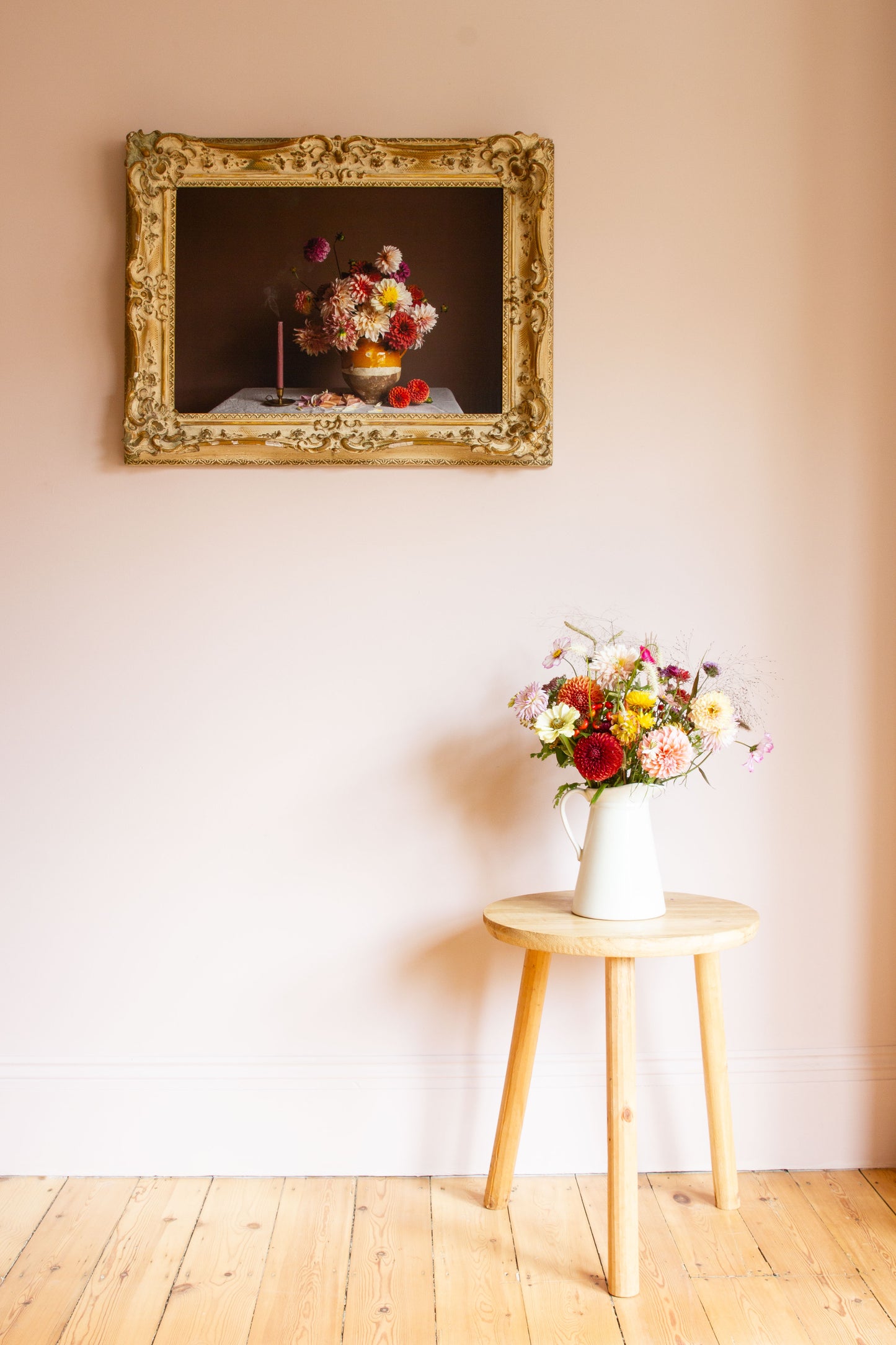 Large framed floral still-life of dahlias by photographer Emma Harris in a calm room with flowers on a table