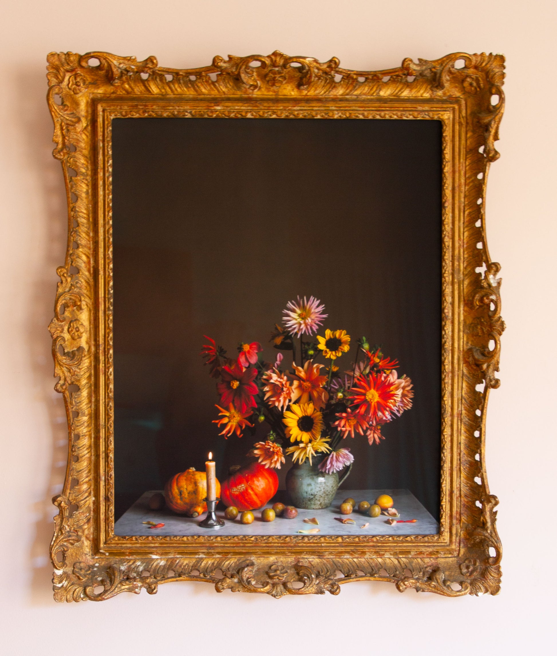 Decorative still life fine art photograph with flowers and fruits in a gold vintage frame.