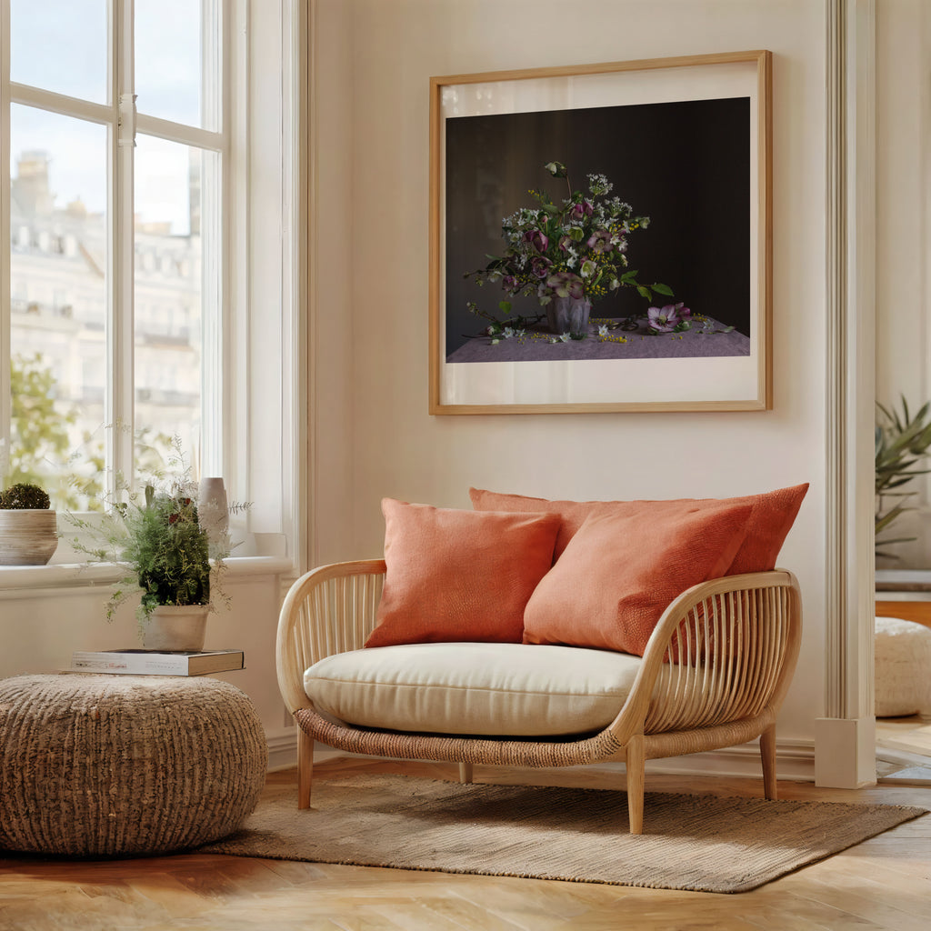 A room with wicker share showing floral artwork of January flowers by Emma Harris