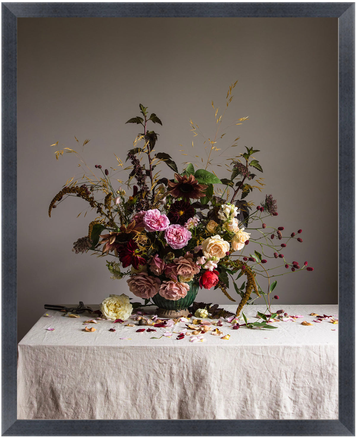 Floral arrangement on a table with a gray background.  flower art