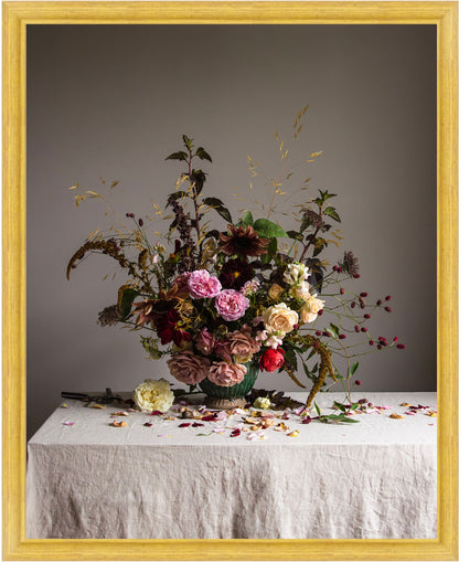 Floral arrangement on a table with a gray background and gold frame.  botanical art