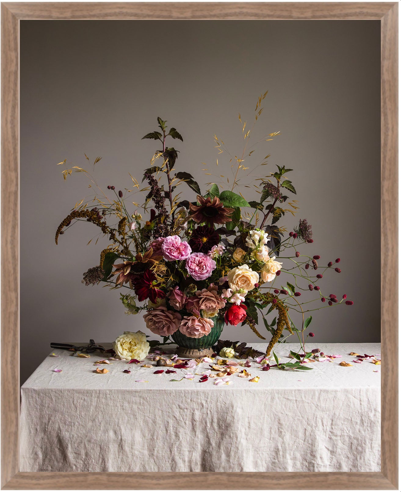 Floral arrangement on a table with a gray background.   Floral artwork