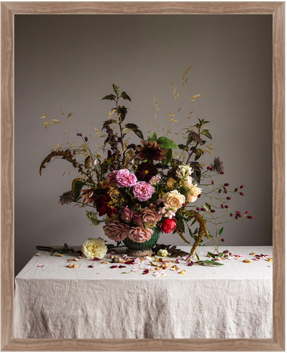 Floral arrangement on a table with a gray background.   Floral artwork
