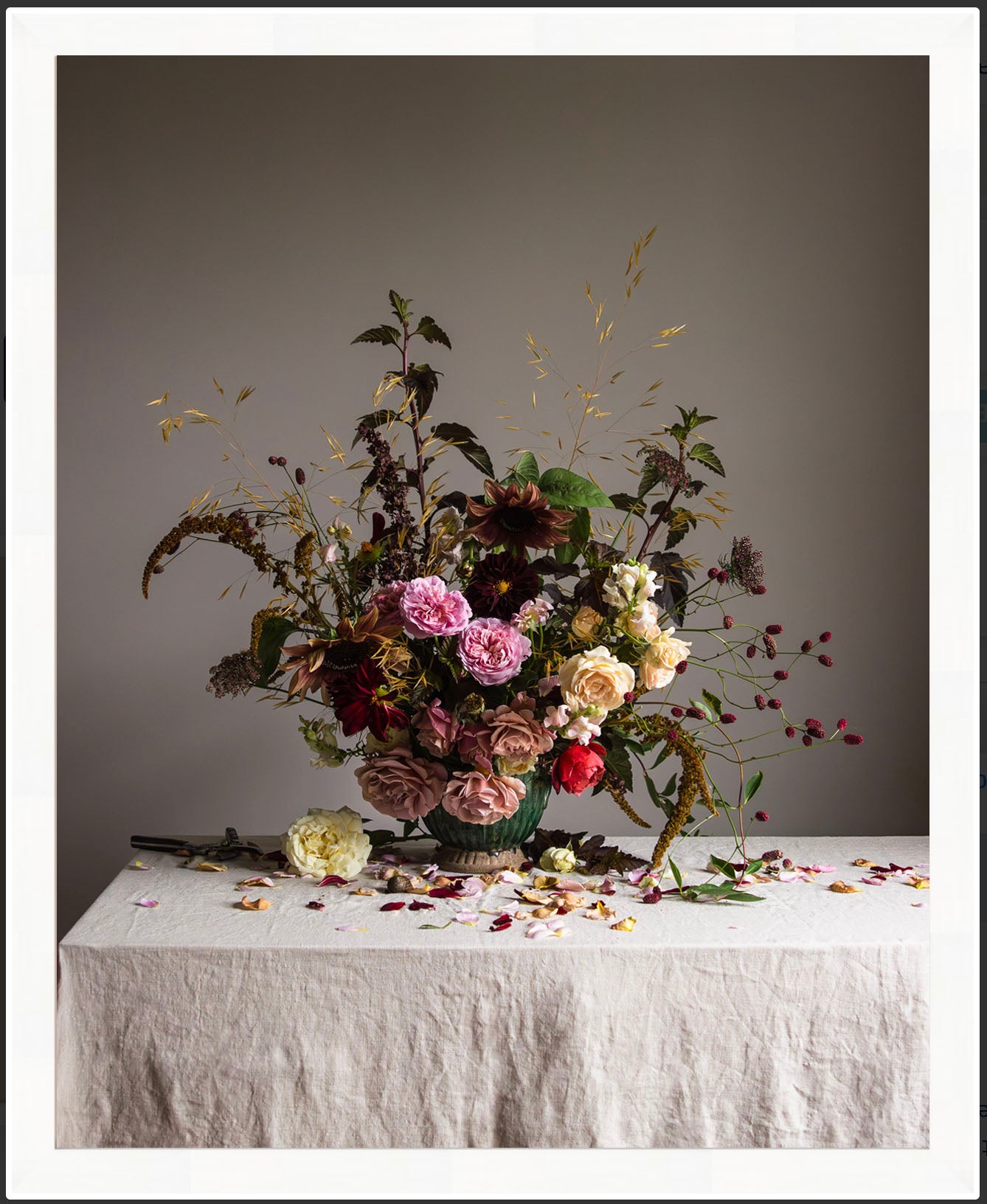 framed Floral arrangement on a table with a plain background.  botanical artwork