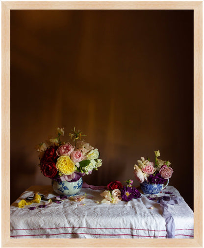 Framed still-life of two floral arrangements on a tablecloth against a dark background by photographer Emma Harris