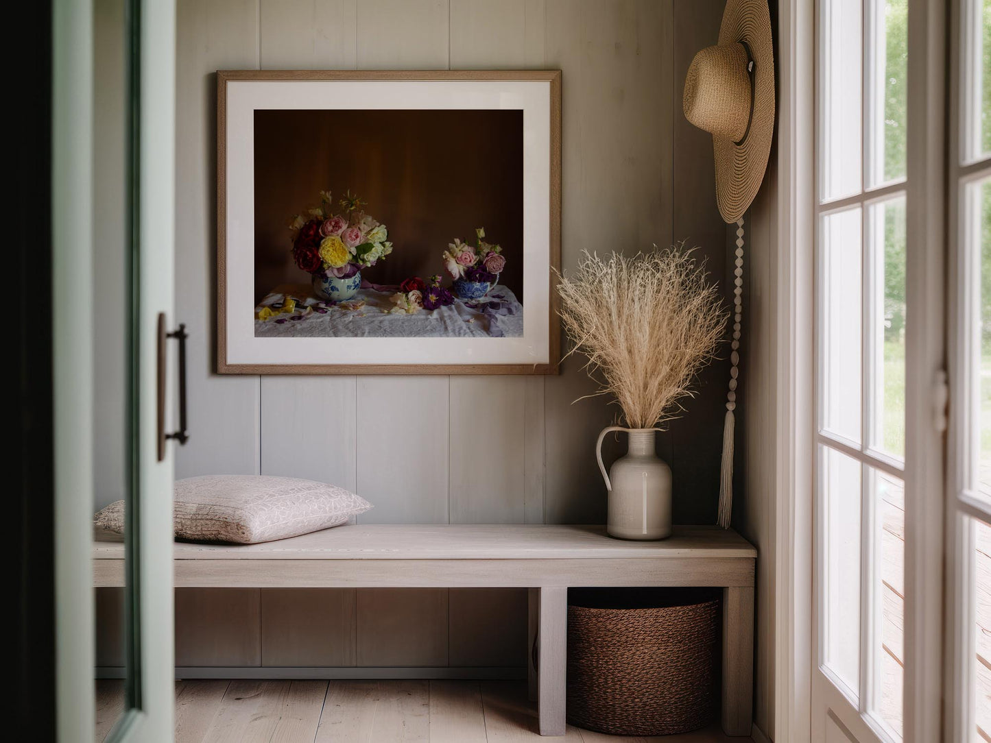 Floral still-life art of roses in a walnut frame in an entrance way.