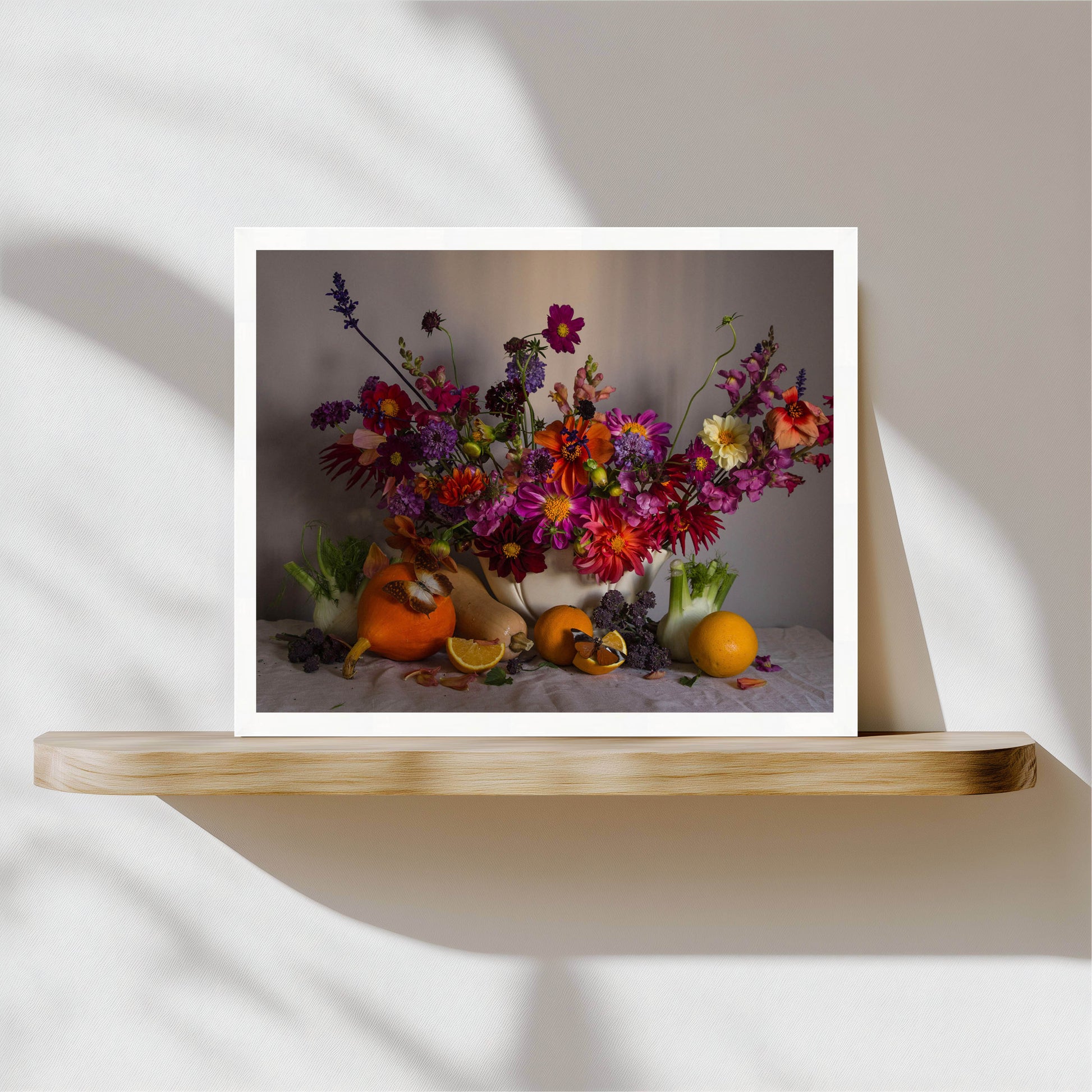 Framed still life with flowers and fruits on a wooden shelf