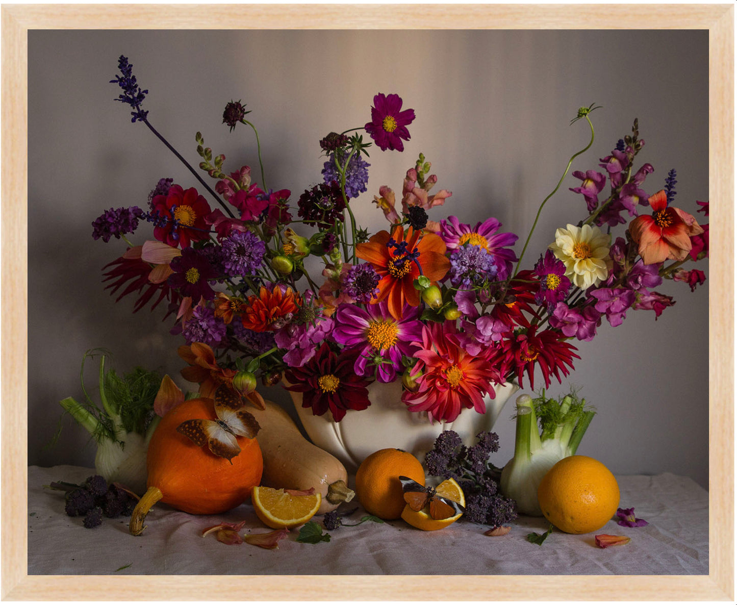 Framed floral Still life with flowers, fruits, and a small fox figurine on a table.