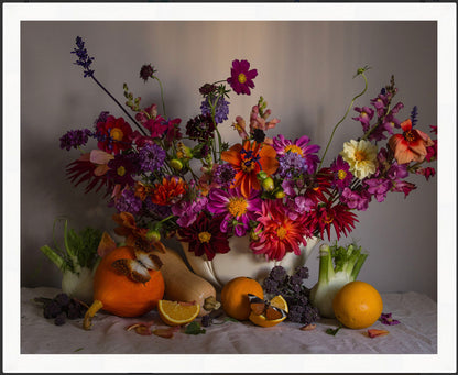 Framed colourful still-life floral arrangement with fruits and vegetables on a neutral background