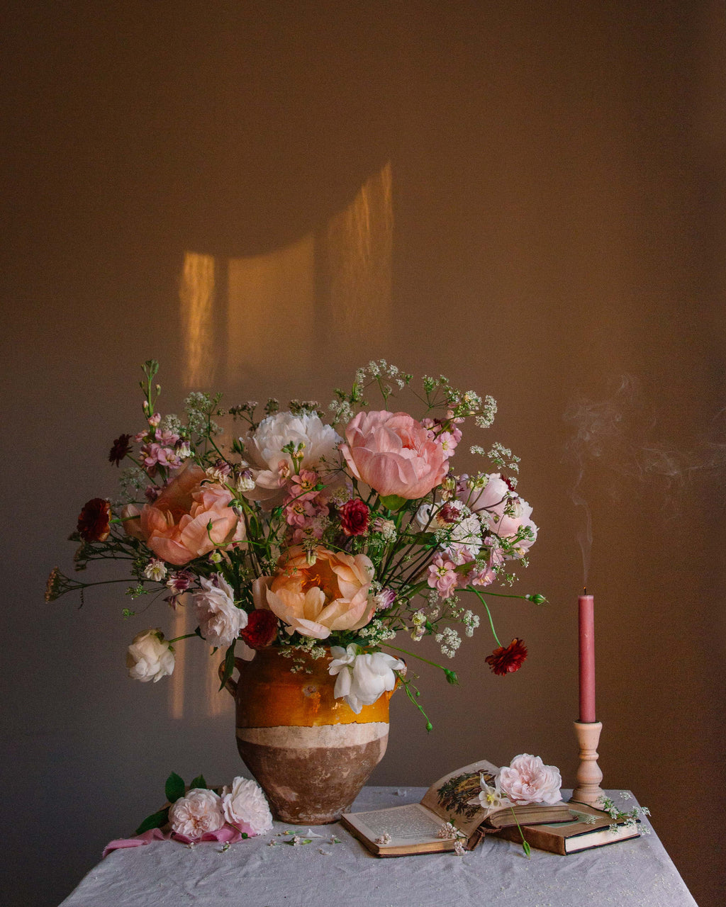 Still-life floral print showing blousy peonies and a smoking candle by Emma Harris