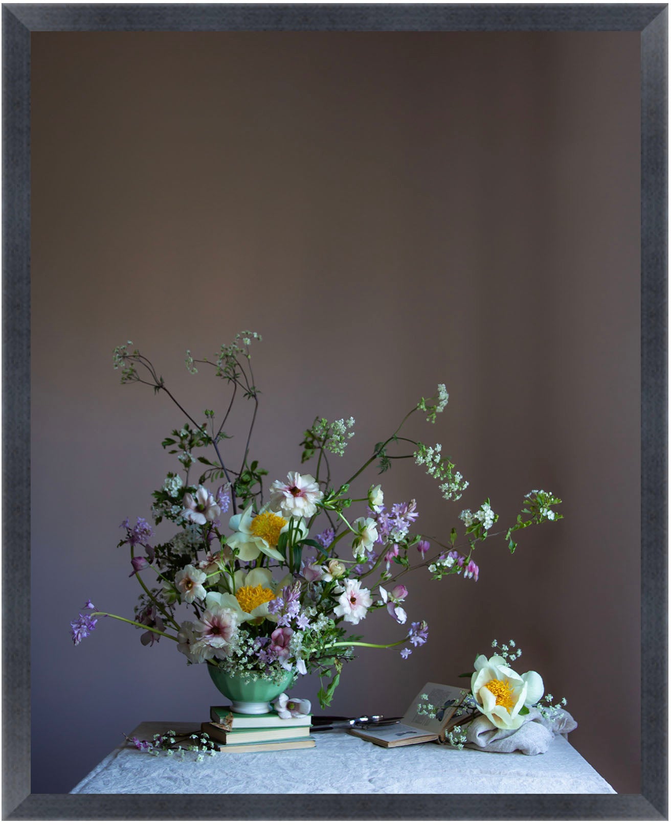 Floral arrangement in a green vase on a table with a dark frame.  Floral art by Emma Harris