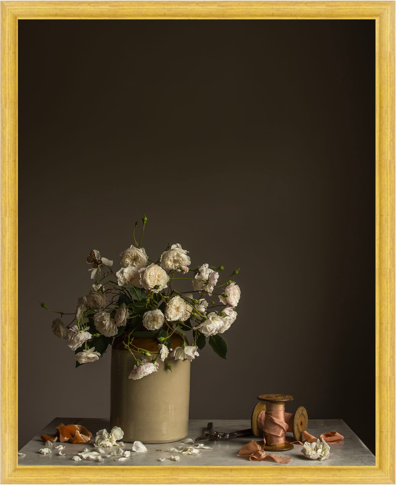 Still life arrangement with flowers in a vase on a table against a dark background.   Botanical artwork by Emma Harris