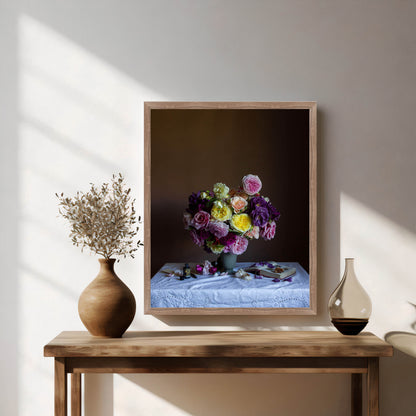 Framed artwork of flowers on a wooden table with decorative vases.