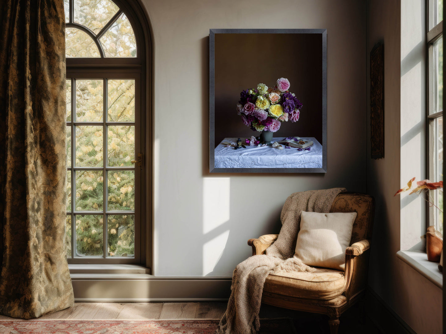 Floral arrangement in a frame on a wall above a cozy armchair with sunlight streaming through a window.