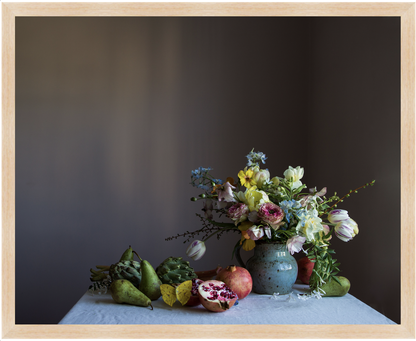 Still life arrangement with flowers, pears, and a fruit on a dark background. Flower art