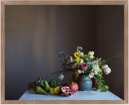 Still life art with flowers, pears, and a pomegranate on a dark background