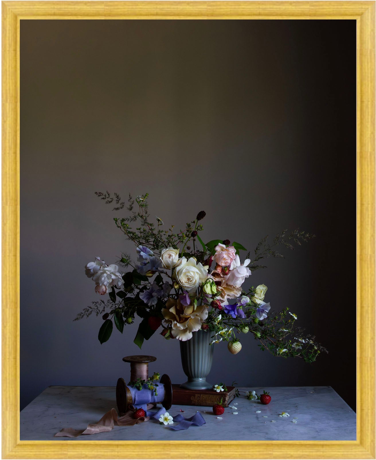 Floral arrangement in a vase on a table against a dark background.   Floral picture.