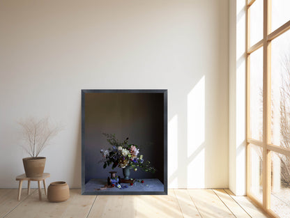 Framed artwork of a floral arrangement in a minimalistic room with large windows.   Floral artwork
