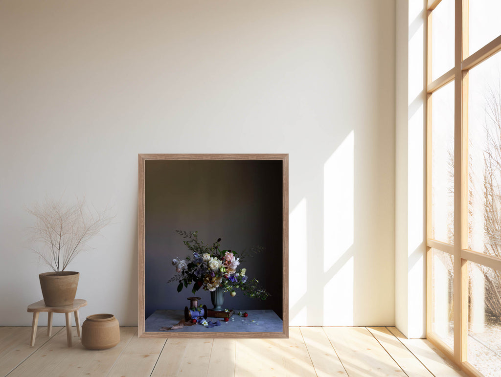Framed artwork of a still life with flowers in a room with large windows.   Botanical print