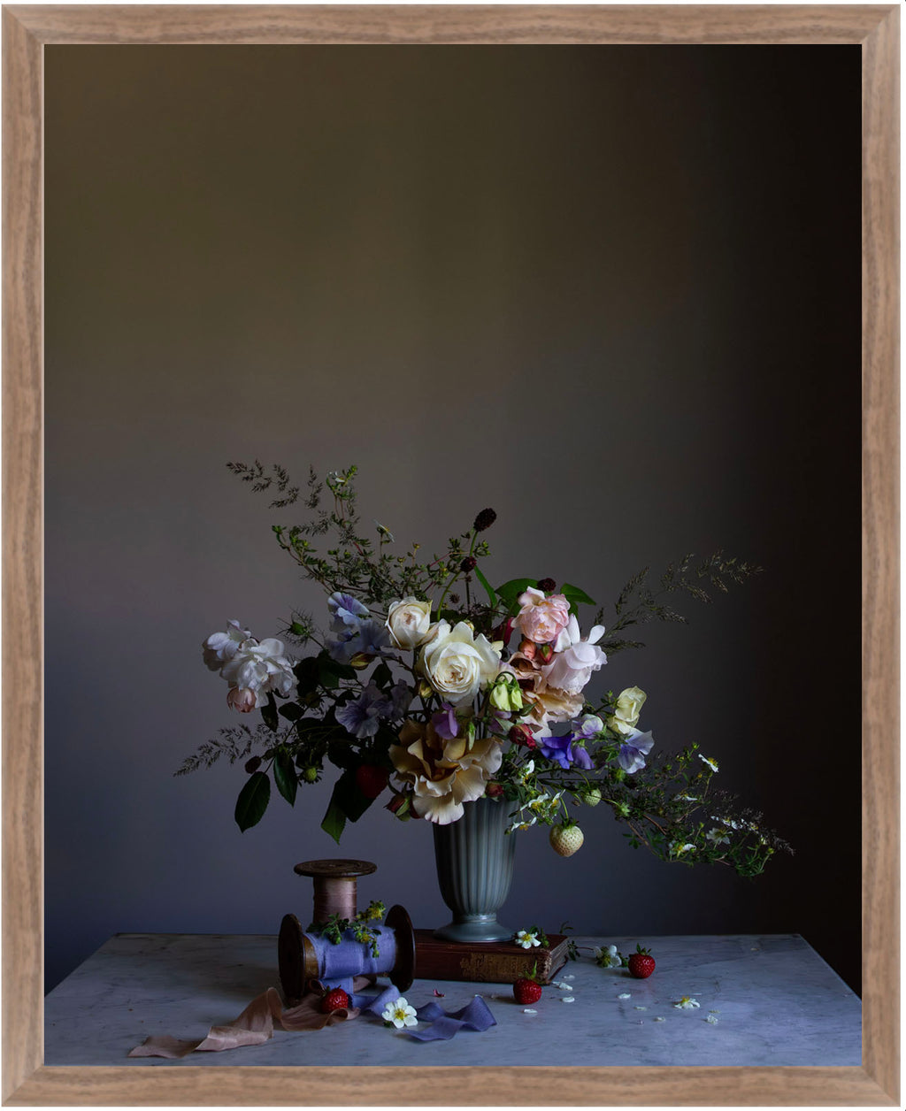 Floral arrangement in a vase on a table with a dark background.   Botanical picture