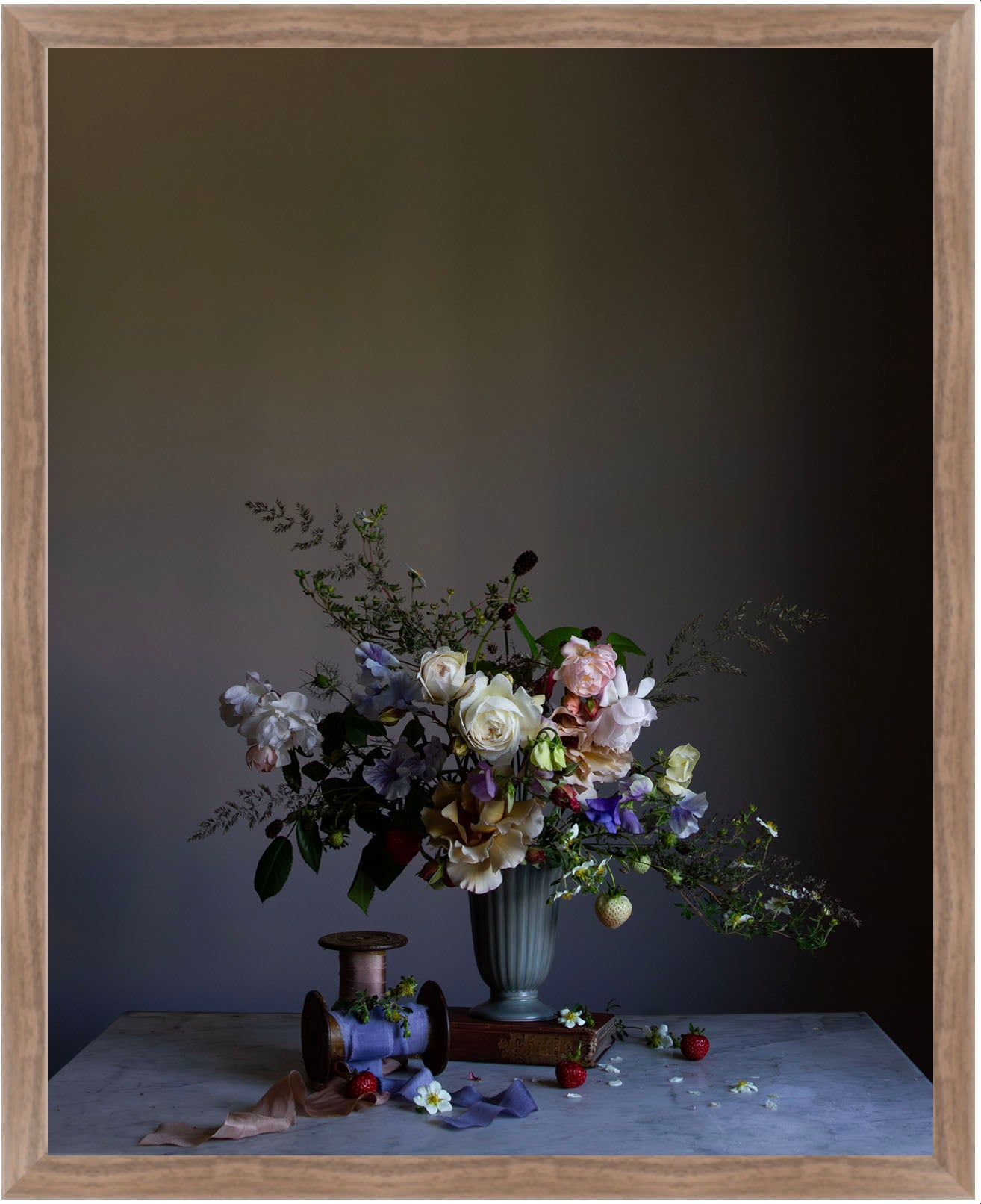 Floral arrangement in a vase on a table with a dark background.   Botanical picture